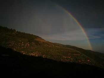 Scenic view of rainbow against sky at night