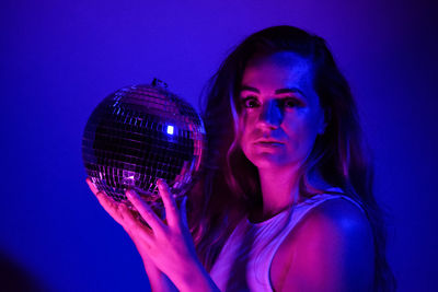 Young woman holding disco ball