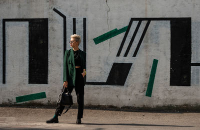 Portrait of young woman standing on street