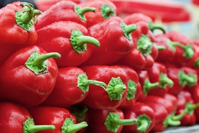 Close-up of red bell peppers arranged at market for sale