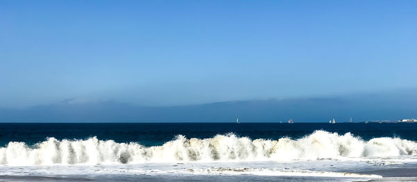 Scenic view of sea against clear blue sky