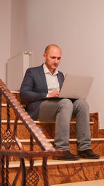 Portrait of businessman using laptop at home