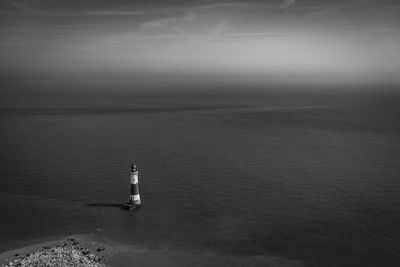 High angle view of lighthouse amidst sea against sky