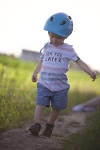 Full length of boy running on field