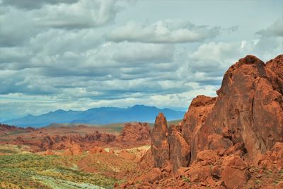 Scenic view of mountains against cloudy sky