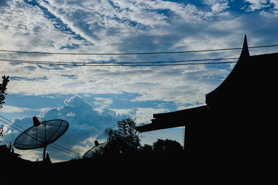 Low angle view of silhouette building against sky