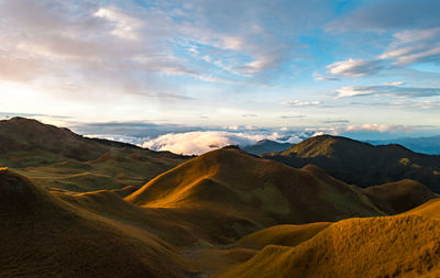 Scenic view of mountains against cloudy sky