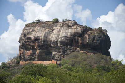 Rock formation on field against sky