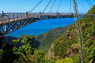 People walking on langkawi sky bridge against sky