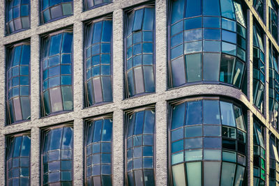 Low angle view of modern building against blue sky