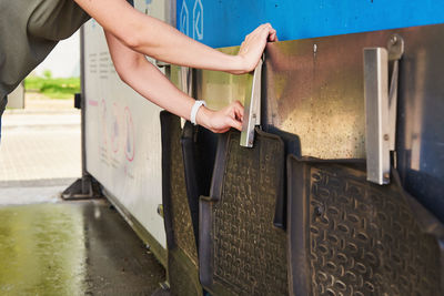 Car washing. woman hangs rubber car wash mats for cleaning. self wash station