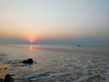 Scenic view of sea against clear sky during sunset