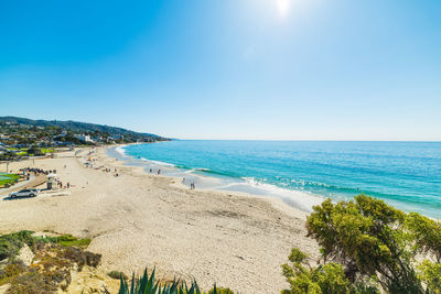 Scenic view of beach against clear blue sky