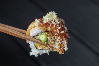Close-up of sushi served on black background