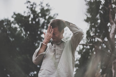 Low angle view of man standing in forest