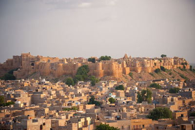 Buildings in city against sky