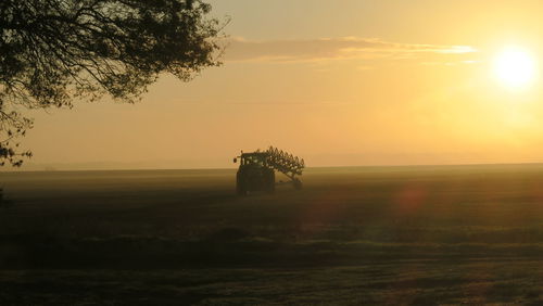 Scenic view of field against sky during sunset