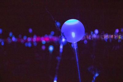 Close-up of illuminated lighting equipment at night