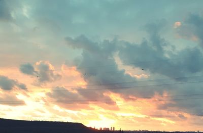 Low angle view of silhouette birds against sky during sunset