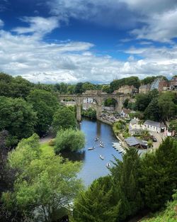 High angle view of river amidst trees against sky