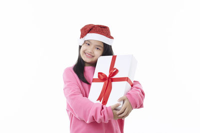 Portrait of a smiling young woman against white background