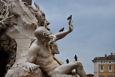 Low angle view of statue against sky