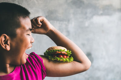 Close-up of young woman eating food