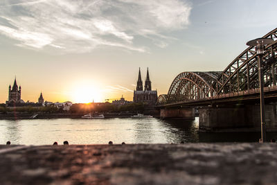 Bridge over river at sunset