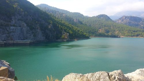 Scenic view of lake and mountains against sky