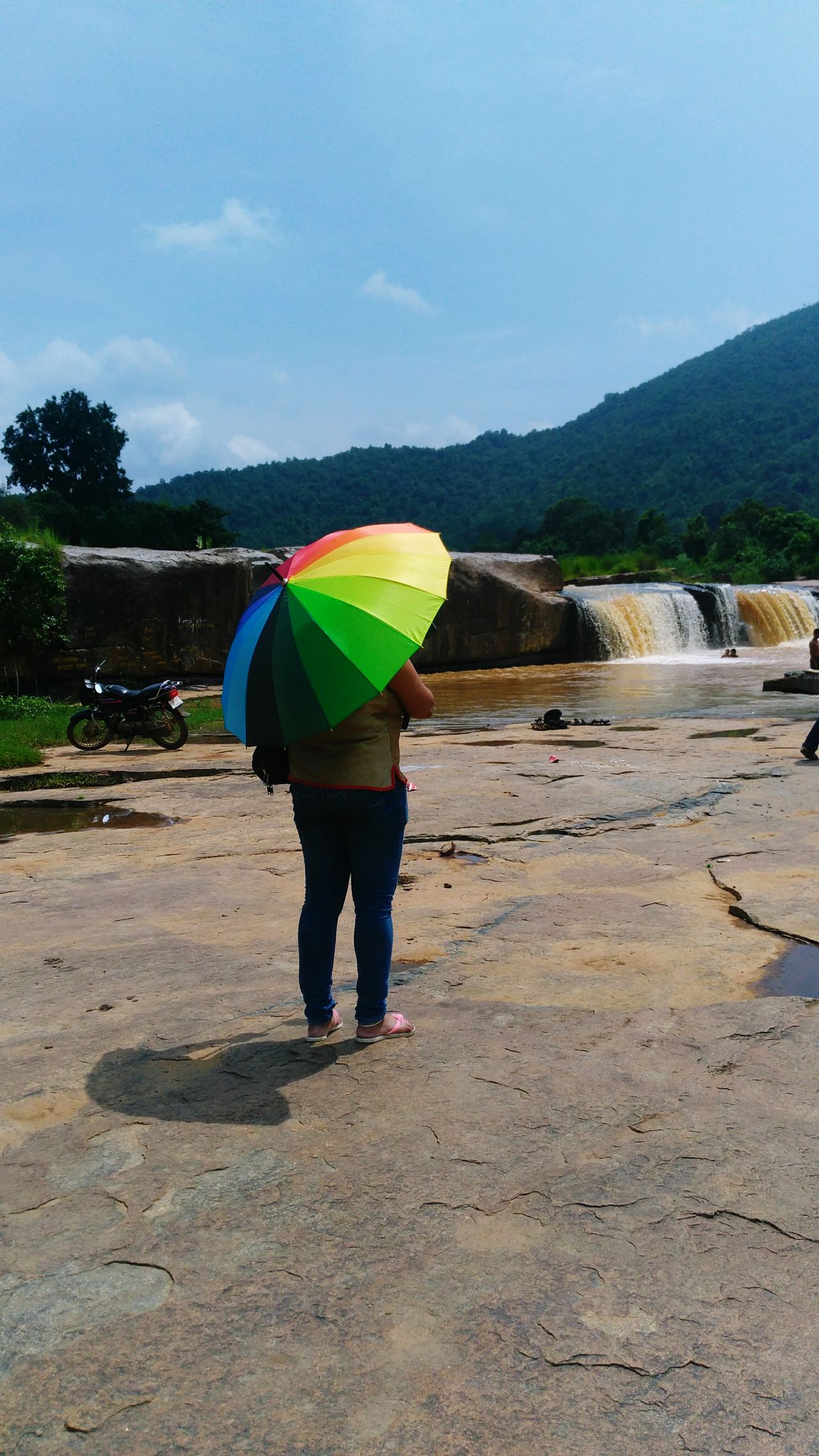 A lady under Umbrella watching the Falls