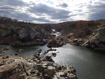 River amidst rock formation against sky