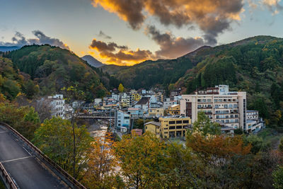 High angle view of buildings and mountains against sky