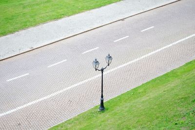 High angle view of lamp post on grass by road