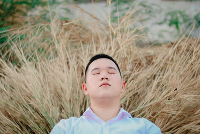 Young man sleeping on hay