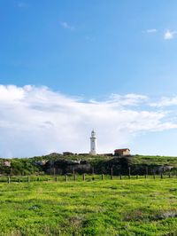 Built structure on field against sky