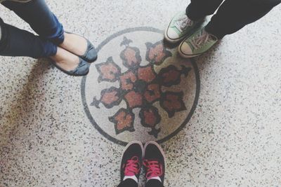 Low section of person standing on tiled floor