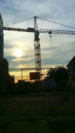 Silhouette of tower against cloudy sky