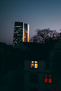 Low angle view of illuminated building against sky at dusk