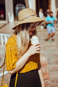 Midsection of woman drinking glass