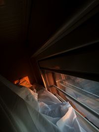 High angle view of bed by window in train