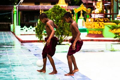 Full length of woman standing by railing