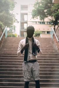 Full length of man standing on staircase