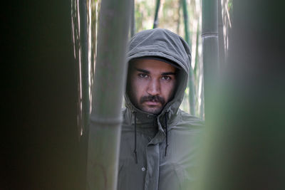 Close-up portrait shot of a moroccan man in the middle of a bamboo forest in morocco