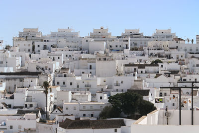 Buildings in city against clear sky