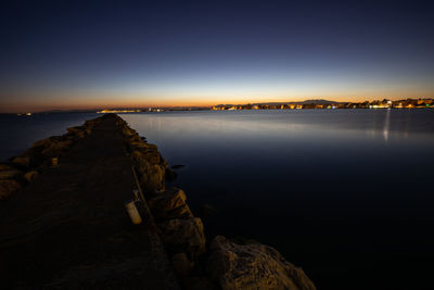 Scenic view of sea against clear sky at sunset