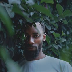 Portrait of young man against plants