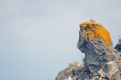 Low angle view of rock formation against sky