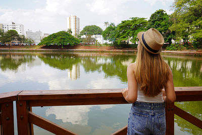 Back view of young traveler woman in the urban park bosque dos buritis in goiania, goias, brazil.