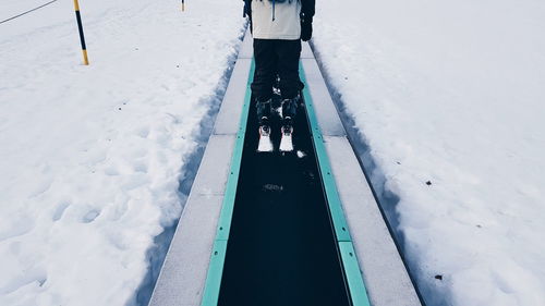 Low section of man skiing during winter