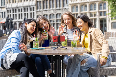 Friends using mobile phone at restaurant